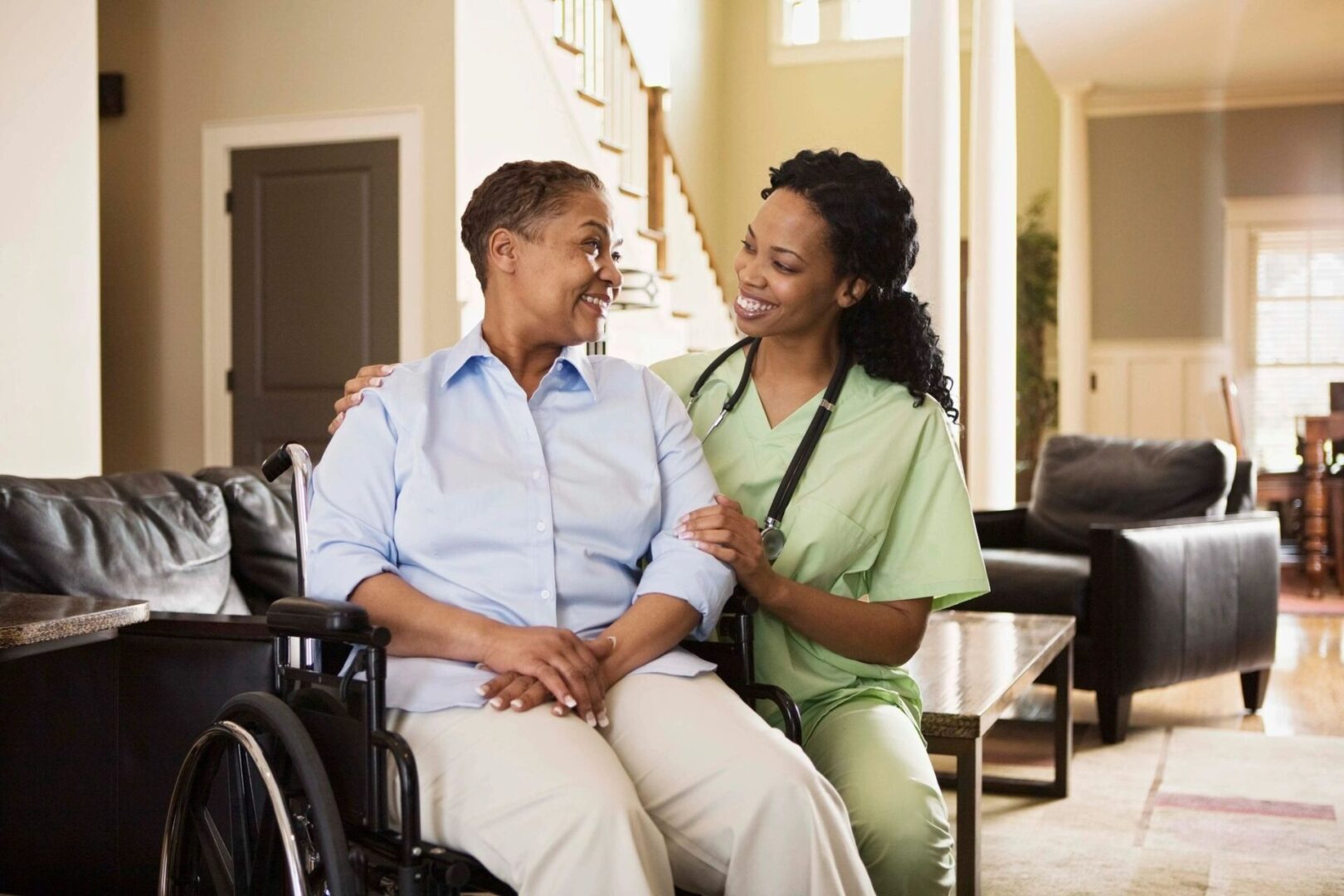 A nurse and an elderly woman sitting in a wheelchair.